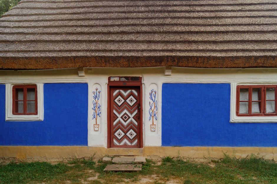 Painted exterior wall of a house with colored paint and window trim