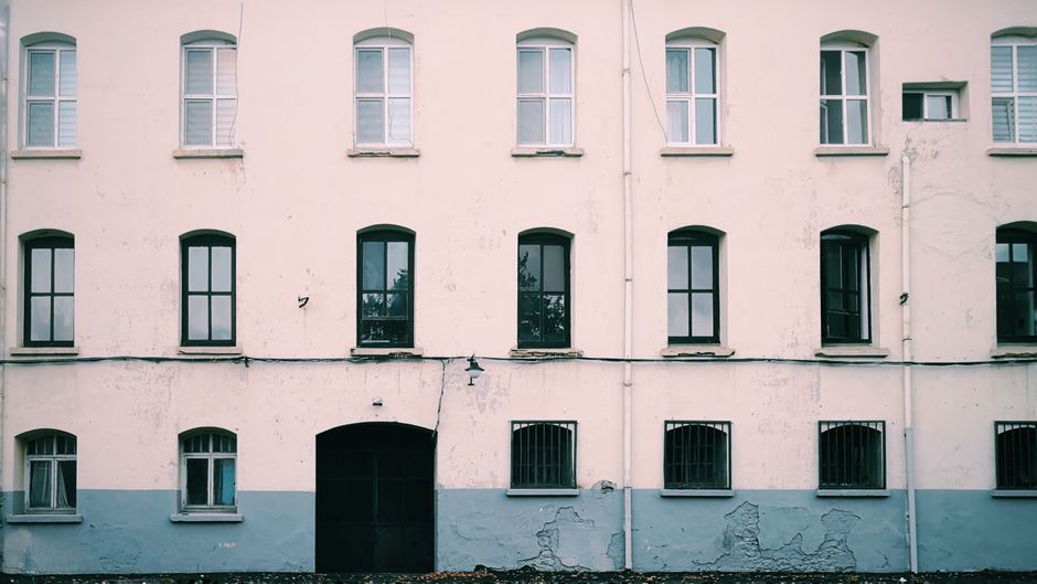 Painted exterior wall of a house with colored paint and window trim