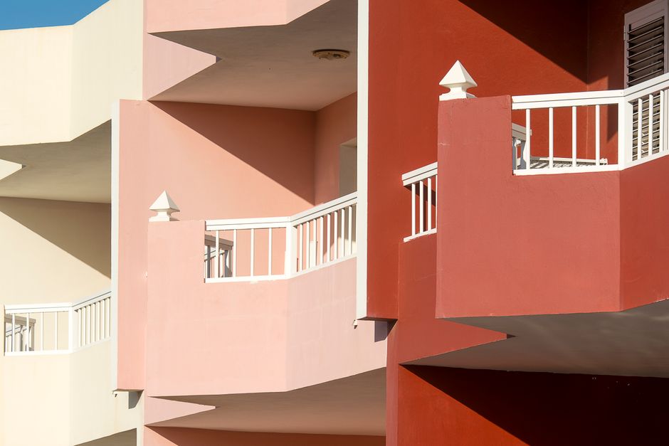 Painted exterior wall of a house with colored paint and window trim