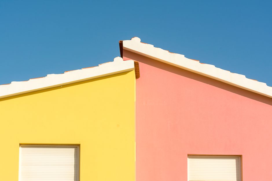 Painted exterior wall of a house with colored paint and window trim